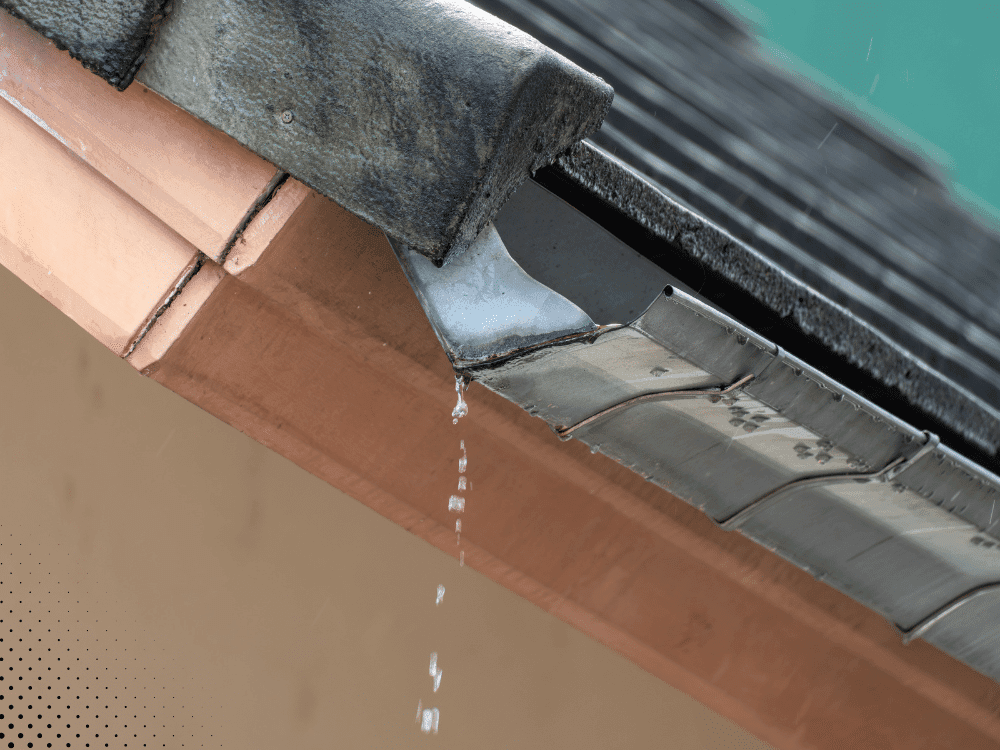 Close-up of leaking gutter joint and fascia board showing drainage issue inspected during home inspection in Buford GA