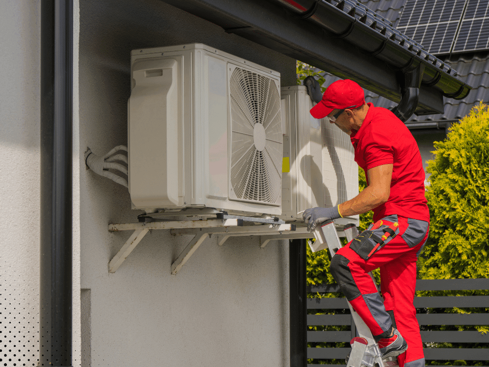 Sure Thing Home Inspections - HVAC technician installing outdoor AC unit on home exterior